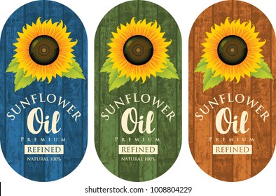 Set of three vector labels for refined sunflower oil with sunflower and the inscription on the wooden background of different colors