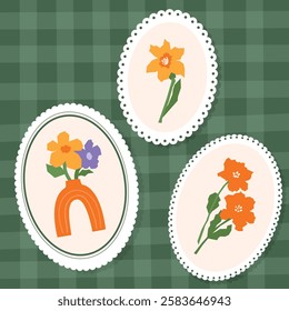 Set of three vintage floral illustrations featuring abstract flowers framed within oval lace borders, arranged on a green plaid background in vintage style.