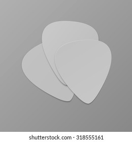 Set of three white picks isolated on the light background with gradient. Mockup for your unique design.