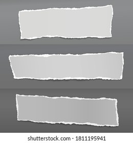 Set of torn of white, gray note, notebook paper strips and pieces stuck on dark gray backgrounds. Vector illustration