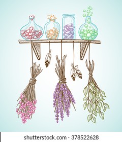 Set of transparent bottles with a magical candy on a shelf with hanging dried flowers