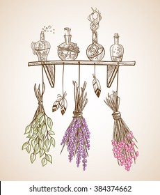 Set of transparent bottles with a magical candy on a shelf with hanging dried flowers