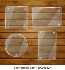 Set of transparent glass plates of different shapes, bolted to wooden planks