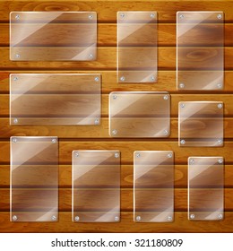 Set of transparent glass plates of different shapes, bolted to wooden planks