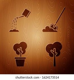 Set Tree, Watering can with water, Tree in pot and Shovel in the ground on wooden background. Vector