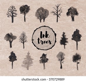 Set of trees hand drawn with ink in Japanese sumi-e style on vintage handmade paper. Vector illustration.