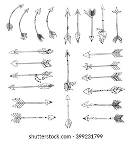 Set of tribal boho arrows on white background. Vector collection of native aztec arrows hand drawn with ink. Decorative elements with feathers, ornaments and beads