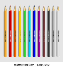 Set of twelve colored pencils on grey background