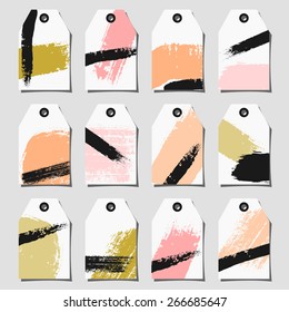 A set of twelve hand drawn brush strokes labels. Light and deep pink, black, pastel orange and fresh green color palette.