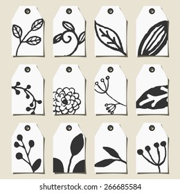 A set of twelve hand drawn floral design labels in black and white.