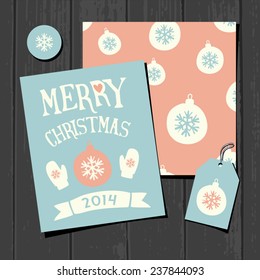 A set of two Christmas greeting card templates, a gift tag and a round sticker on a gray wooden background.