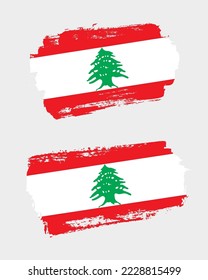 Set of two creative brush painted flags of Lebanon country with solid background