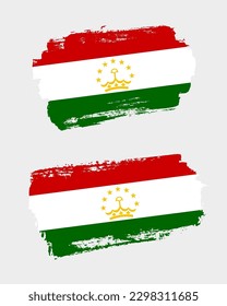 Set of two creative brush painted flags of Tajikistan country with solid background