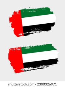 Set of two creative brush painted flags of United Arab Emirates country with solid background