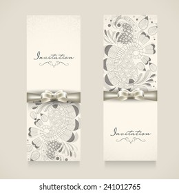 Set of two floral decorated invitation card in black and white binding with shiny silver ribbon with stylish text Invitation.
