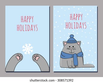 set of two greeting cards with a kitten on a snowy background and catâ??s paws catching a snowflake