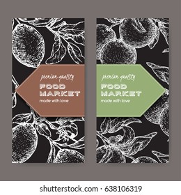 Set of two labels with fresh lemon and lime fruits on black. Includes hand drawn elements.