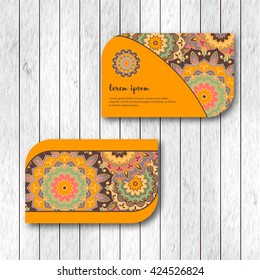 Set of two ornamental floral mandala cards, visiting template, orange color. Vintage decorative elements. Indian, asian, arabic, islamic, ottoman motif. Vector illustration.