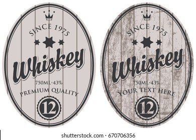 Set of two oval labels for whiskey on a gray wooden background with calligraphic inscription, crown and stars.