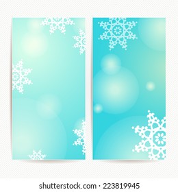 Set of two vertical holidays christmas banners with blue background, light bokehs and snowflakes