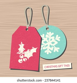 A set of two vintage Christmas gift and sale tags on wooden background.