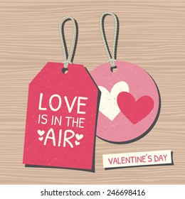 A set of two vintage Valentine's Day gift and sale tags on wooden background.