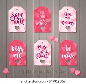 Set of Valentines day gift tags with decorative elements and romantic quotes. Holiday badge vector design with calligraphy. Handwritten modern lettering and hearts on wooden background.