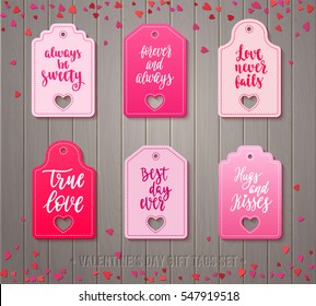 Set of Valentines day gift tags with decorative elements and romantic quotes. Holiday badge vector design with calligraphy. Handwritten modern lettering and hearts on wooden background.