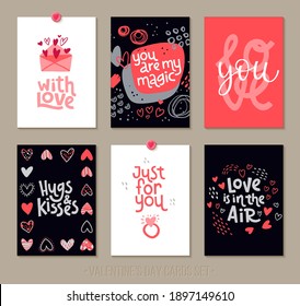 Set Valentine's Day greeting cards with lettering and decorative hand drawn love elements. Vector illustration for season invitations, cards, posters and flyers.