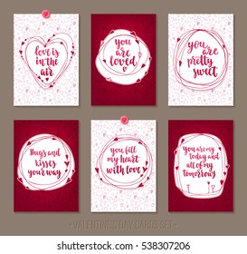 Set Valentine's Day greeting cards with handwritten brush calligraphy and decorative elements. Decorative vector illustration for season invitations, cards, posters and flyers.