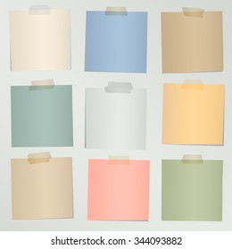Set of various colorful note papers with adhesive tape on gray background