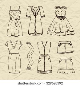 Set of vector contour outline dresses, scarf, skirt, shorts. Women's clothing on old crumpled torn paper background