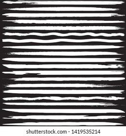 Set of vector grunge brushes. White paint strokes on black background. Abstract handmade lines