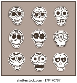 Set of vector hand drawn mexican skulls with flowers and hearts.