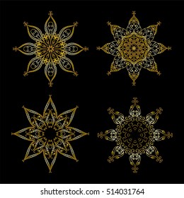 Set of vector ornate snowflakes or beautiful winter stars. Premium gold style. Object isolated on black background. Hand drawing, sketch doodle style. Elements for design