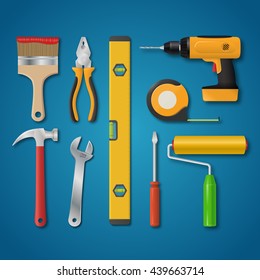 Set of vector realistic tools isolated on a blue background. Electric drill, hammer, pliers, paint roller, screwdriver, spanner, paintbrush, meter, spirit level. Hand tools for home renovation
