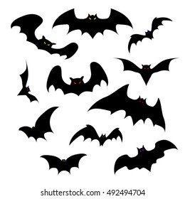 Set of vector silhouettes of bats with glowing eyes on a white background. Halloween party.