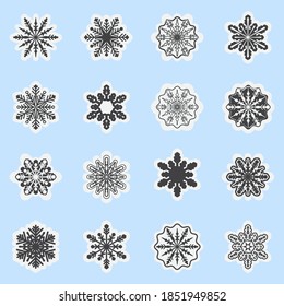 A set of vector snowflakes. Christmas snowflakes isolated on a blue background. Collection of New Year's design.