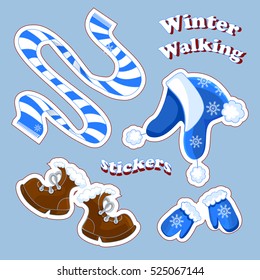 Set of vector stickers about the winter holidays and walks in the fresh air. Striped blue scarf, a hat with pom-poms, mittens with snowflakes, brown boots. Winter clothes. Cartoon style. Isolated.
