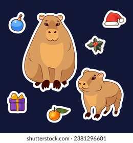 Set of vector stickers of two cute capybaras, mistletoe, gift box, Santa Claus cap and orange on a blue background, for New Year and Christmas