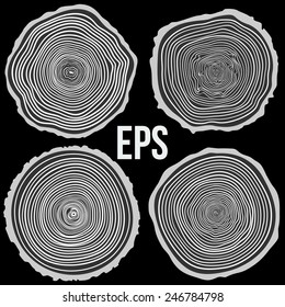 Set of vector tree rings background and saw cut tree trunk. Conceptual graphics on black.