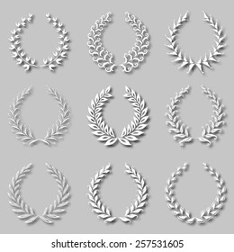 Set of vector white laurel wreaths with shadows on the gray background for page decoration, web design. Floral elements in vintage style. Vector illustration EPS 10.