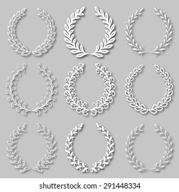Set of vector white laurel wreaths, monograms with shadows on the gray background for page decoration, web design. Floral elements in vintage style. Vector illustration EPS 10.