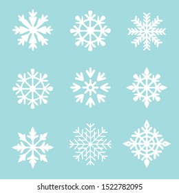 Set of vector white snowflakes on a blue background. Christmas winter icons.