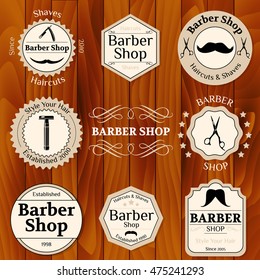 Set of vintage barber shop badges with typographics and design elements on wooden background vector illustration