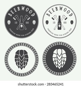 Set of vintage beer and pub logos, labels and emblems with bottles, hops, axes and wheat