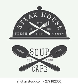 Set of vintage cafe and steak house logo, badge and emblem with spoons, forks and knifes