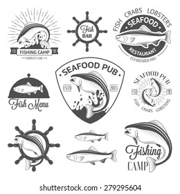 Set of vintage fish logos with helm, sunburst and salmons