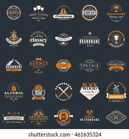Set of vintage retro logotype templates. Collection of 25 items. Vector logo design elements. Icon symbols. Labels. Badges. White and orange colors on dark background