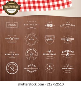 Set of vintage style elements for labels and badges for restaurants, with wood texture and elements of restaurant inventory in the background 